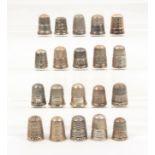 Twenty British silver thimbles mostly with decorative borders, mostly early 20th Century (20)