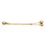 A Victorian gilded metal skirt lifter the ball form mount to an alternate solid and open link
