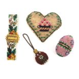 A beadwork covered egg form etui, and three other pieces, the etui with pink beaded ground, the