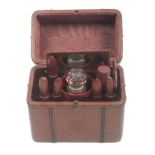 A leather cased sewing companion in the form of a travelling trunk the front stamped in an oval with