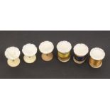 A set of six flowerhead mother of pearl top reel holders on brass stems and bone bases, one with