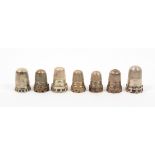 Seven late 19th Century/early 20th Century silver thimbles with cable type or other fancy friezes