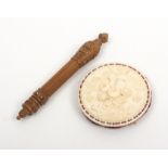 An ivory pin cushion and a good stiletto, the 19th Century ivory pin cushion of disc form, one