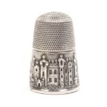 A pictorial silver thimble, the frieze with a view of Windsor Castle, 1/3 of base rim lacking,