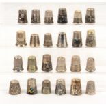 Twenty-four mainly continental white metal thimbles mostly with decorative friezes (24)