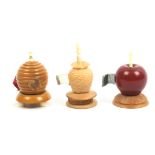 Three tape measures in vegetable ivory comprising one painted as a red apple, slightly reduced