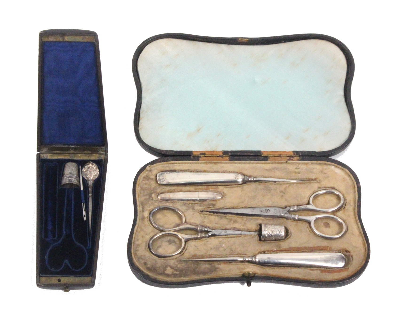 A leather cased sewing set and an etui, the black leather cased sewing set with six silver