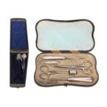 A leather cased sewing set and an etui, the black leather cased sewing set with six silver