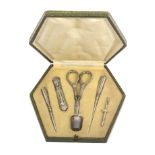 An early 20th Century continental sewing companion, the hexagonal case covered in green paper, the