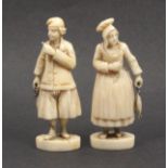 A pair of Dieppe carved ivory figures of male and female fisher folk in traditional costume, each