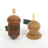 Two vegetable ivory tape measures comprising a pierced acorn form example with slightly reduced