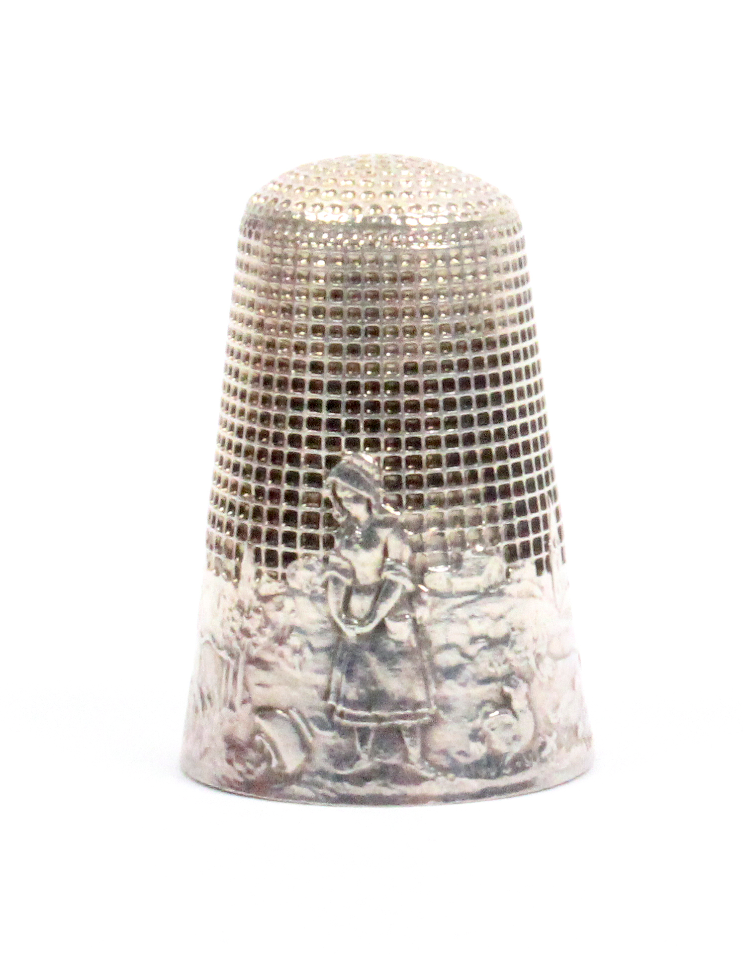 A French silver 'fairy tale' thimble, 'The Milkmaid and the Pot of Milk', with gate, village
