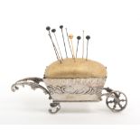 A 19th Century continental novelty silver pin cushion in the form of a wheelbarrow with leaf and