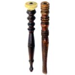 Two 19th Century spindle form wooden knitting sticks comprising a turned tapering example with