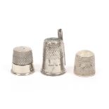 Two gadet thimbles comprising a silver and white metal example, the upper section lifting off to