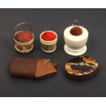 Five pin cushions comprising a floral painted bone example of basket form, 4.5cm, a 19th Century