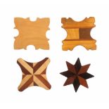 Four wooden silk winders, three in allenate woods one plain, largest 5.5cm (4)