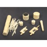 A group of 19th Century Chinese carved ivory sewing tools comprising a cylinder netting case