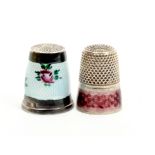 Two silver and enamel decorated thimbles, one with floral enamel body stamped '925', the other