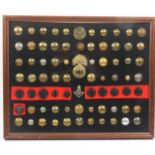 Buttons and badges - a framed display 70+ mostly Indian army in brass, ten black Gurkha buttons