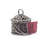 A late 18th Century silver filigree tape measure of cylinder form, quill work sides with vacant