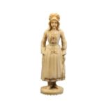 A 19th Century French carved ivory figural standing needle case, in the form of a fisherwoman in