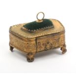 A sewing companion for a doll, circa 1870, in gilt metal decorated with leaf scrolls and other