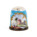 An 18th Century English Staffordshire enamel thimble, decorated with a house by a river, a figure on