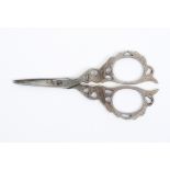 A pair of late 19th Century continental steel scissors, tapering blades the arms pierced and