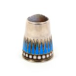 A Norwegian silver and enamel stone top thimble, the frieze with blue enamel triangles over white