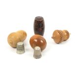 Four thimble cases comprising three in vegetable ivory, two with thimbles, and a Tartan ware (M'