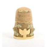 An attractive two-colour gold and jewelled 19th Century thimble, the frosted frieze with a two-