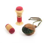 Three vegetable ivory pin cushions comprising a standing example with reel stem, 6.5cm, a double