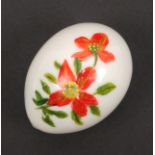An opaque glass egg form hand cooler painted with a flowering branch, 8.5cm