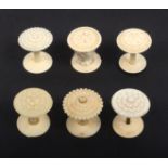 Six various ivory top reel holders all with fancy tops, one with incorrect base, largest, 3.5cm high