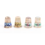 Four attractive continental silver and enamel decorated thimbles comprising two with floral enamel