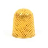 An 18th Century gold thimble of small size, punched over a plain rim