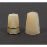 Two 19th Century mother of pearl thimbles comprising an example with plain frieze between two copper