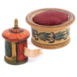 An early painted Tunbridge ware pin cushion and a tape measure, the circular pin cushion with
