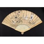 A 19th Century French ivory fan, the sticks carved with harlequin type figures over flowers and