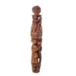 An early 19th Century figural carved coquilla needle case of cylinder form, each section carved with