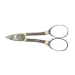 A pair of early 19th Century French gold mounted steel scissors, the short blades with flower head