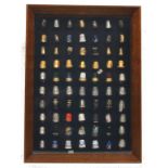 Modern thimbles - mostly metal in a display cabinet, a few enamel, 70, cabinet, 43 x 32cm