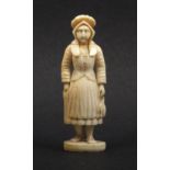 A 19th Century French Dieppe carved ivory figural standing needle case, well carved as a fisherwoman