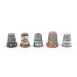 Five attractive continental white metal thimbles, comprising two with stone tops one with an