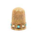 A 15ct gold thimble the frieze set with a band of alternate turquoise and pearl coloured stones in