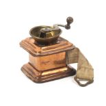 A brass and copper novelty tape measure in the form of a coffee grinder, the complete tape printed