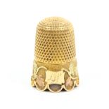 An attractive Victorian gold thimble the frosted frieze overlaid in variant coloured gold with