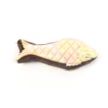 A mother of pearl pin cushion in the form of a fish one side carved and engraved to represent a