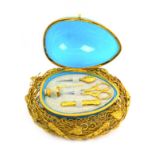 A French sewing companion in the form of a blue glass frosted egg in a gilded metal nest, circa